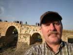 In front of the historic Delal Bridge in Zakho.