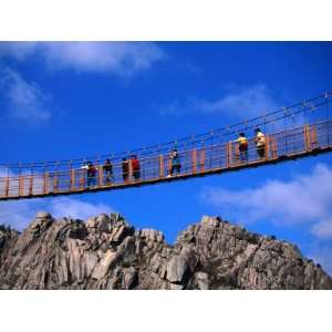 Hikers Crossing Steel Suspension Bridge Over Crevasse, Wolchulsan 