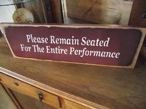 PLEASE REMAIN SEATED 4 ENTIRE PERFORMANCE Bath sign  